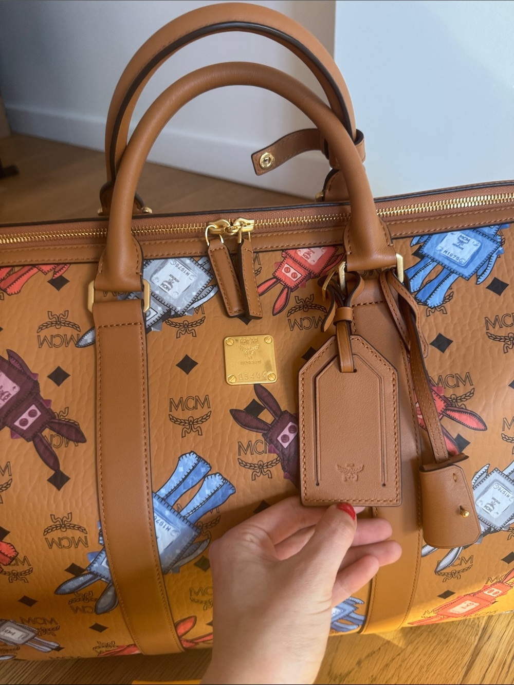 Brand New MCM Cognac Visetos Weekender with Multicolor Perfume Bottle Print. - Picture 3 of 7